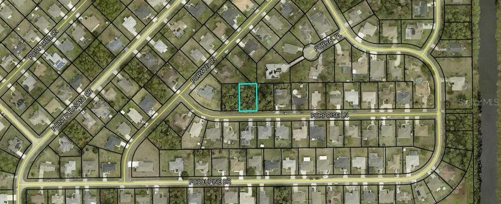 This is an aerial map showing a vacant residential lot highlighted in blue on Porpoise Lane — 5 PORPOISE LANE, PALM COAST, FL