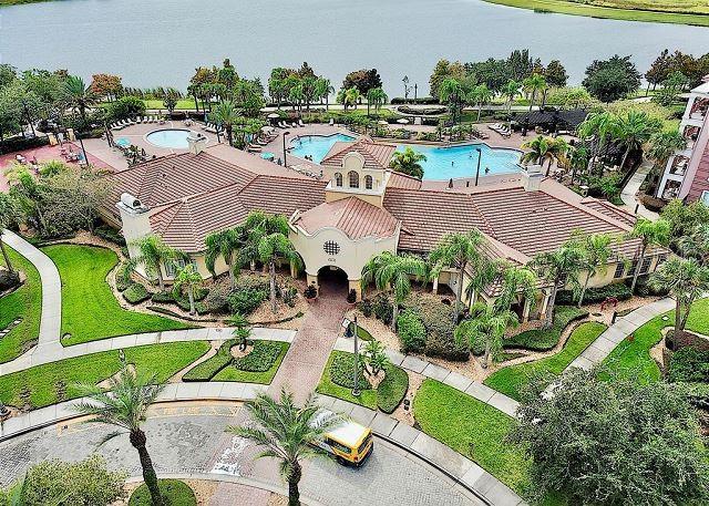 An aerial view of a community clubhouse with a swimming pool and lakefront landscaping — 4862 CAYVIEW AVENUE UNIT 20909, ORLANDO, FL
