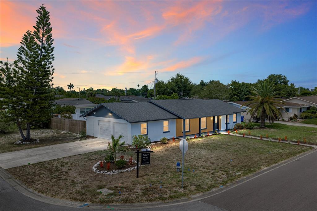 An aerial view shows a single-story house with a swimming pool on a corner lot — 3810 18TH AVENUE W, BRADENTON, FL