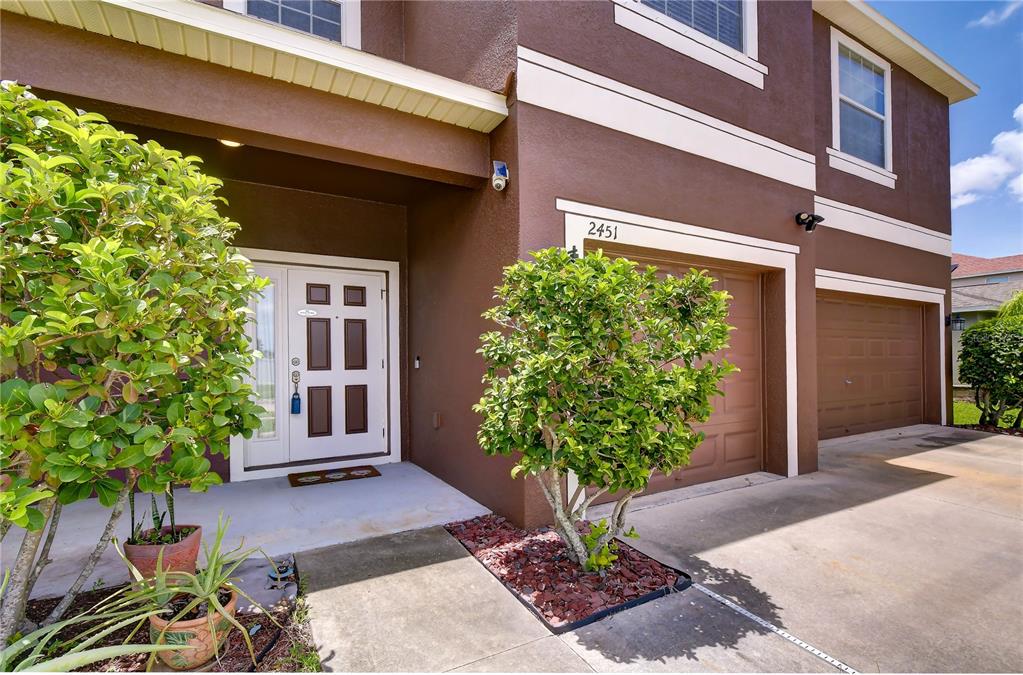 A carpeted room features arched openings, a ceiling fan, and light-colored walls — 2451 DAKOTA ROCK DRIVE, RUSKIN, FL