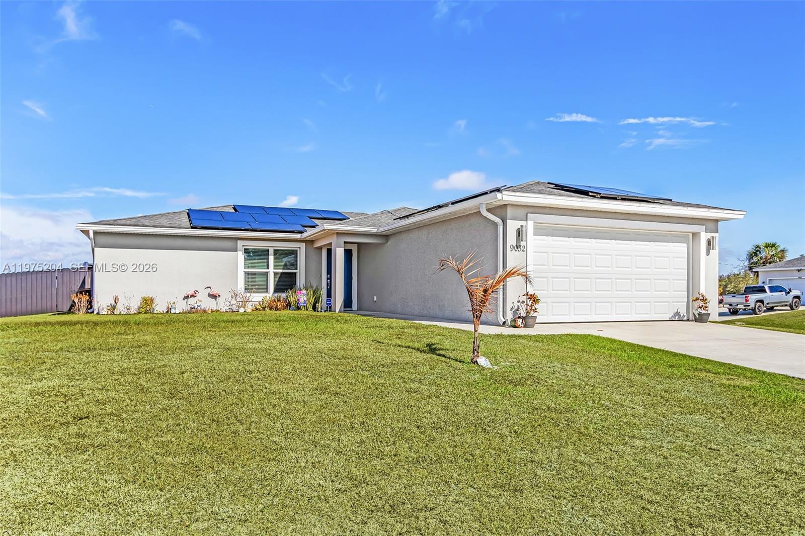A kitchen features dark wood cabinets, granite countertops, stainless steel appliances, and a breakfast bar — 9032 Meadow Circle, La Belle FL 33935, LA BELLE, FL