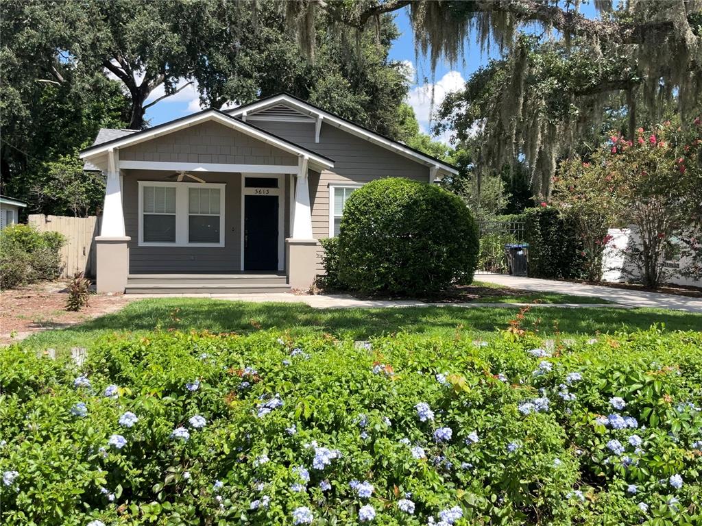 A single-story house with a covered front porch and a large bush in the yard — 3613 S SUMMERLIN AVENUE, ORLANDO, FL