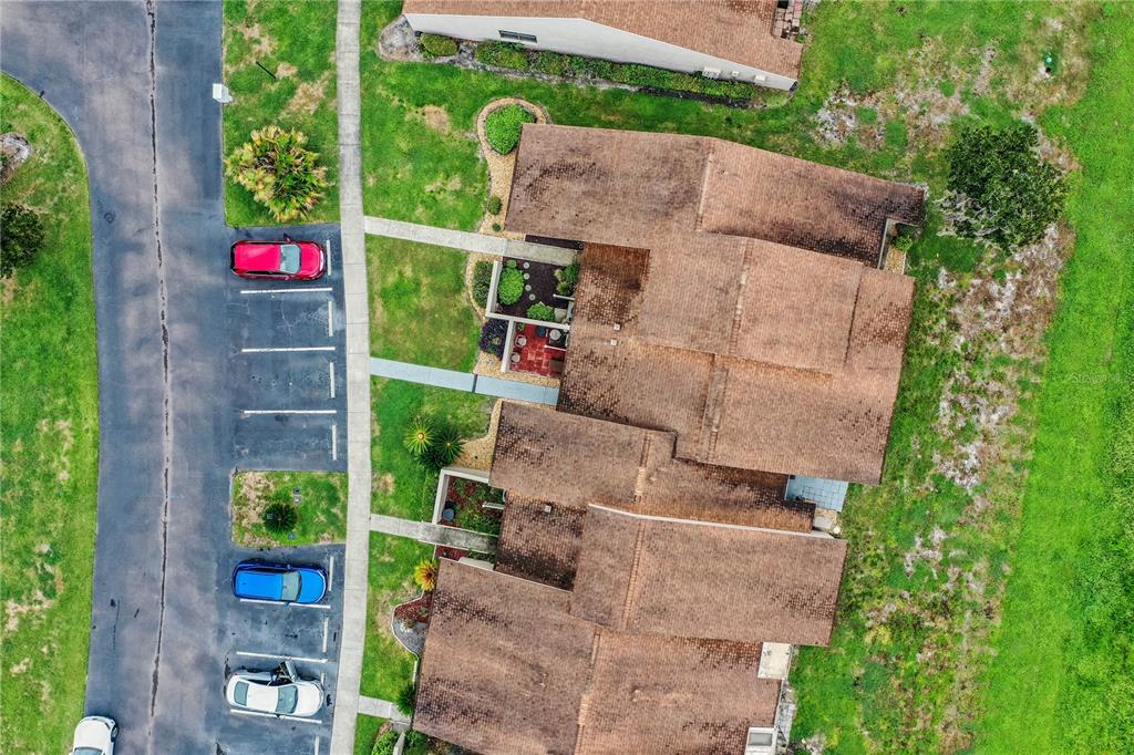 An aerial view shows a multi-unit residential building with a parking lot and green space — 5225 IMPERIAL LAKES BOULEVARD UNIT 22, MULBERRY, FL