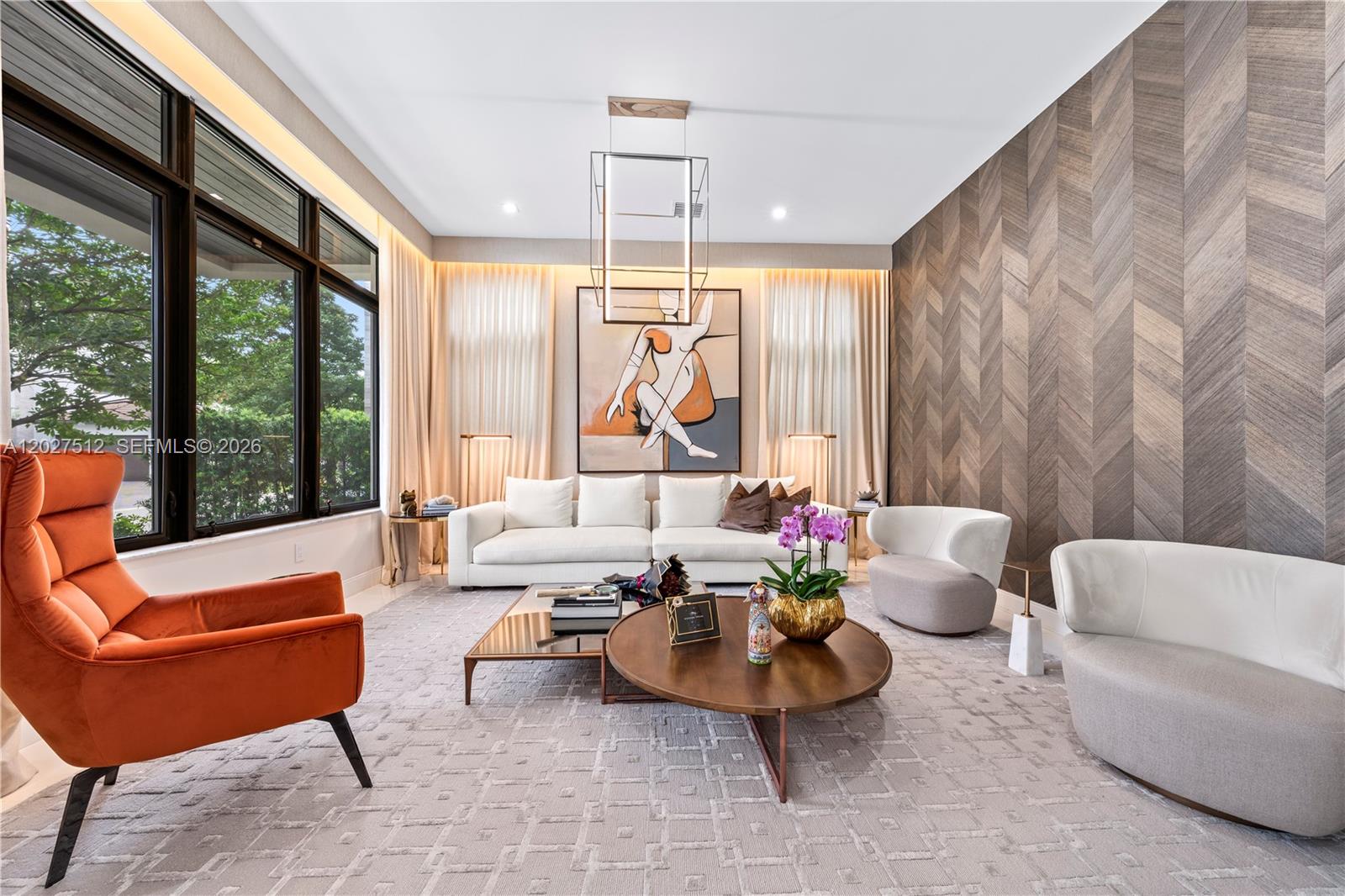 A modern living room features a white sofa, orange armchair, and chevron-patterned wood wall — 8162 NW 48th Ter, Doral FL 33166, DORAL, FL