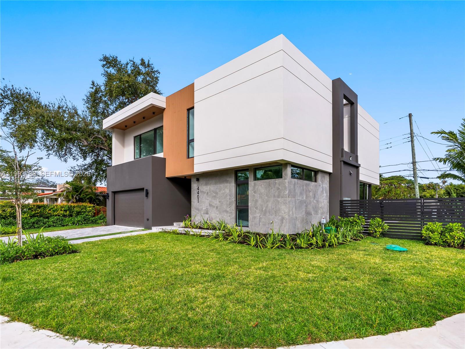 A modern two-story house features a mix of white, gray, and wood-toned exterior finishes — 4401 SW 14th St, Miami FL 33134, MIAMI, FL