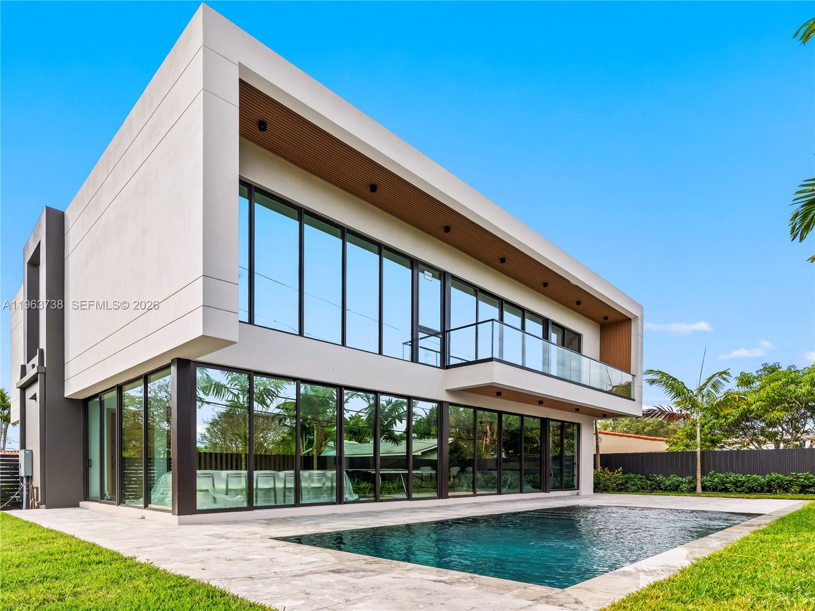 A modern two-story house with floor-to-ceiling windows, a balcony, and a backyard swimming pool — 4401 SW 14th St, Miami FL 33134, MIAMI, FL
