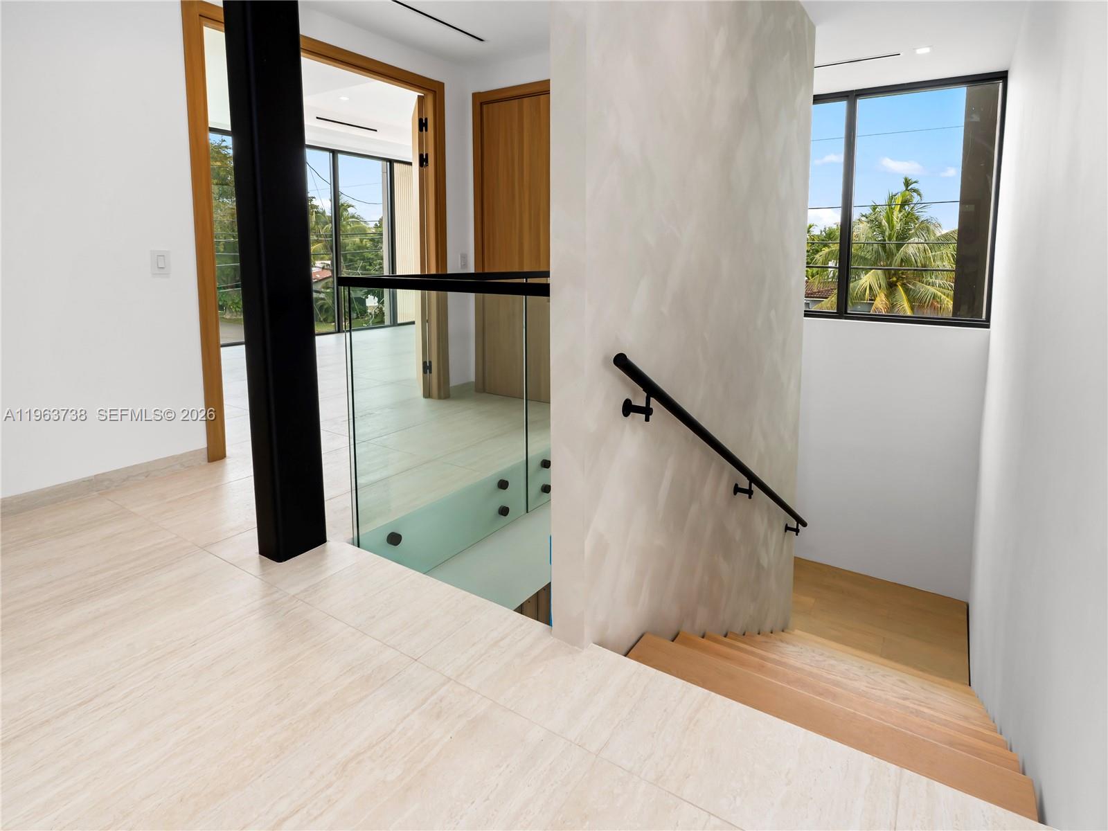 A modern kitchen features a central island, a round dining table, and light wood cabinetry — 4401 SW 14th St, Miami FL 33134, MIAMI, FL