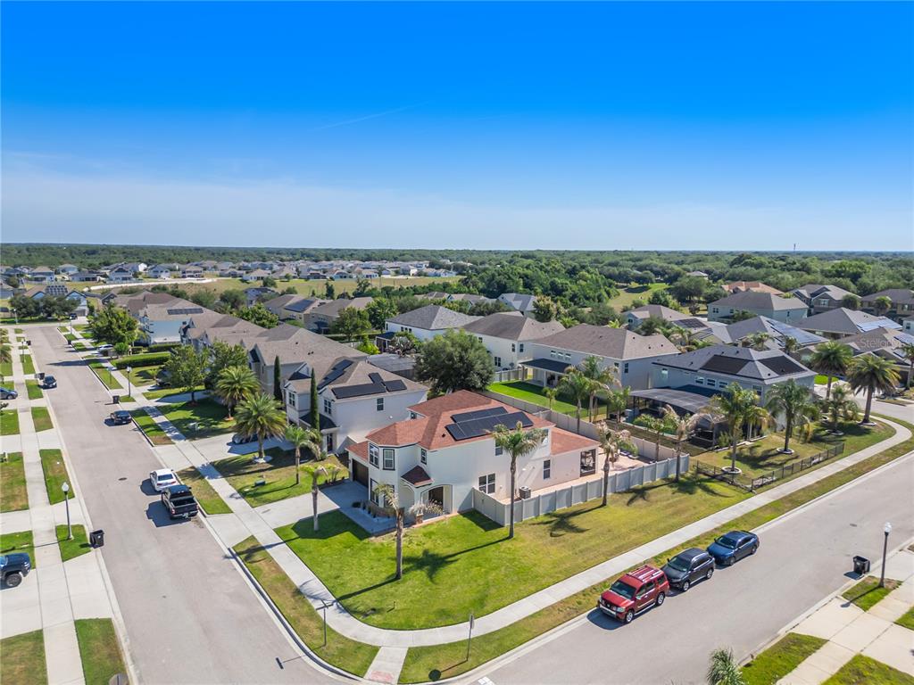 An aerial view shows a suburban neighborhood with houses, streets, and parked cars — 2001 RED BLUFF AVENUE, APOPKA, FL