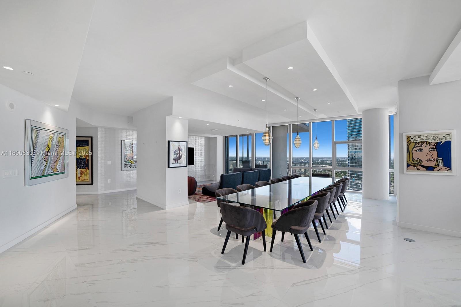 A modern dining room features a glass table, gray chairs, and marble floors with city views — 851 NE 1st Ave, Miami FL 33132, MIAMI, FL