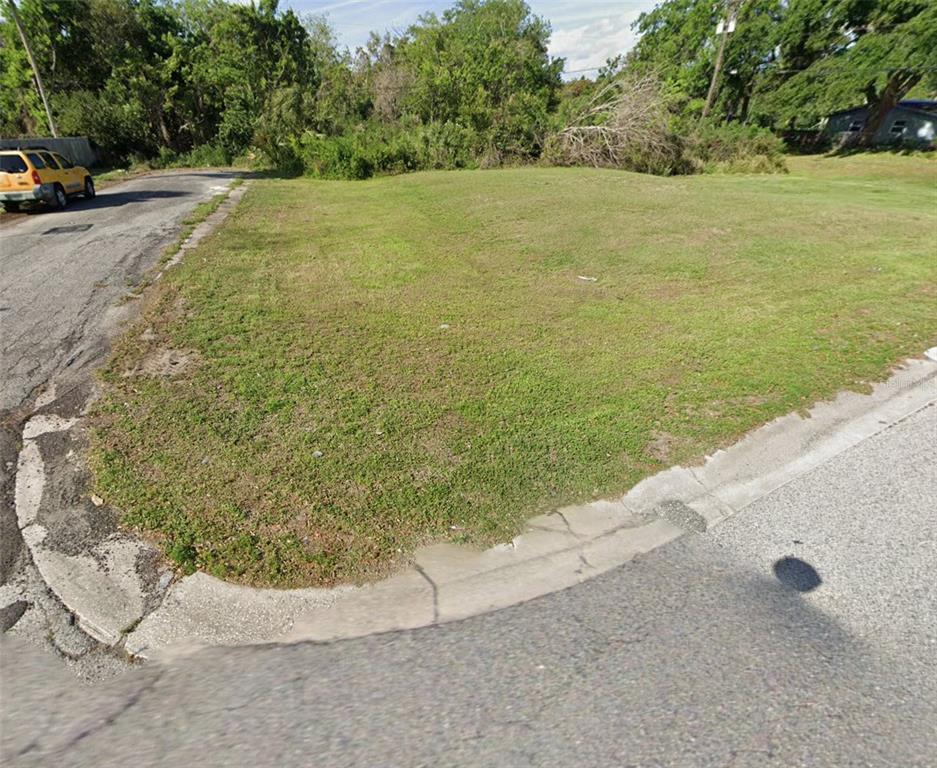 A vacant, grassy corner lot sits at the intersection of two paved residential streets — 3080 ELDER STREET, TITUSVILLE, FL