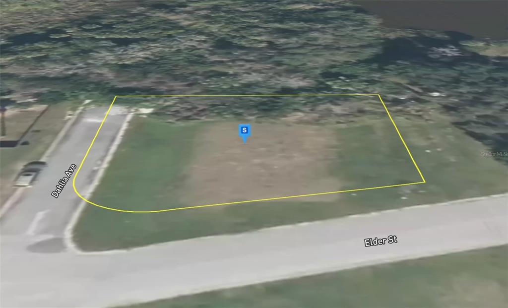 An aerial view shows a vacant, rectangular corner lot bordered by Dahlia Avenue and Elder Street — 3080 ELDER STREET, TITUSVILLE, FL