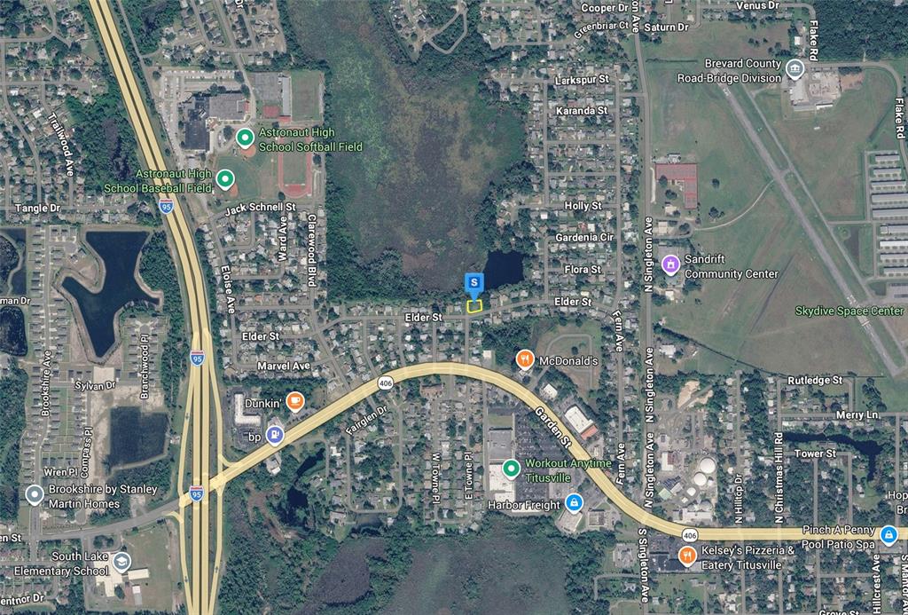 This is an aerial map showing a residential area with a highlighted property lot — 3080 ELDER STREET, TITUSVILLE, FL
