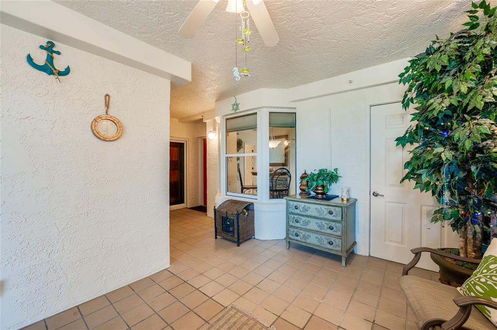 A tiled entryway features a blue anchor wall decoration, a bay window, and a dresser — 4555 S ATLANTIC AVENUE UNIT 4304, PORT ORANGE, FL