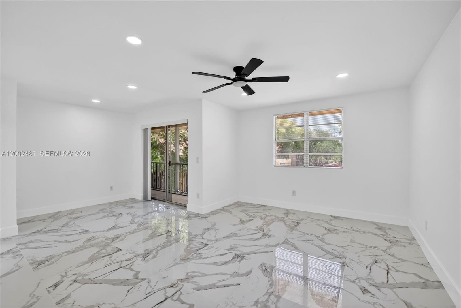 A bright room features white walls, a black ceiling fan, and polished marble-patterned tile flooring — 1227 SW 46th Ave # 314, Pompano Beach FL 33069, POMPANO BEACH, FL