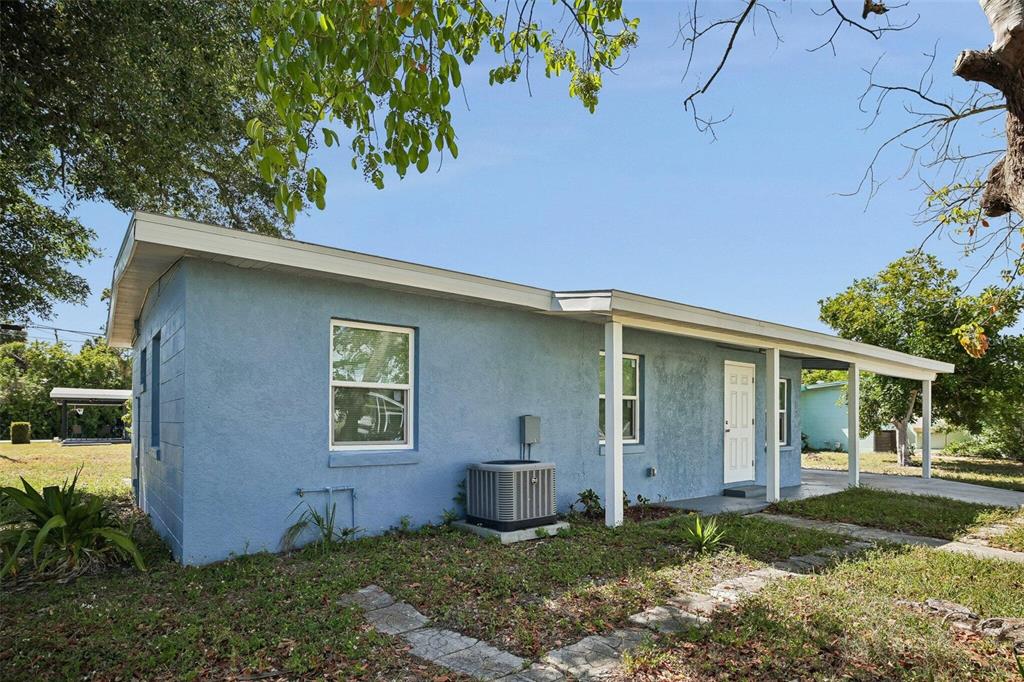 A blue, single-story house with a covered front porch and an exterior air conditioning unit — 2321 EDNOR STREET, PORT CHARLOTTE, FL