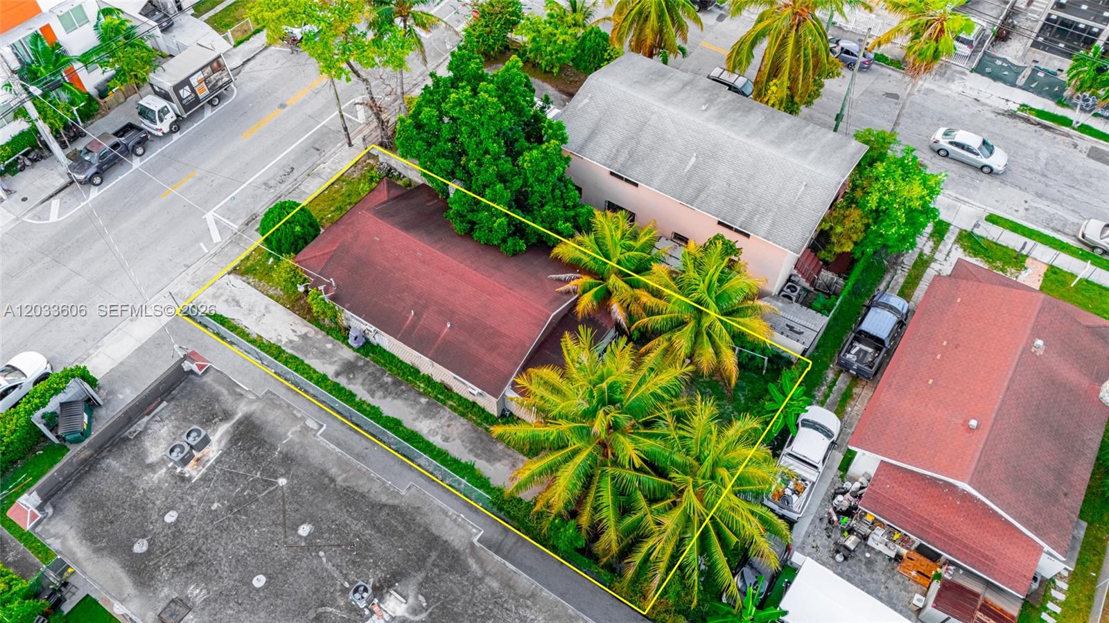 An aerial view shows a house with a red roof surrounded by palm trees — 1267 NW 3rd St, Miami FL 33125, MIAMI, FL