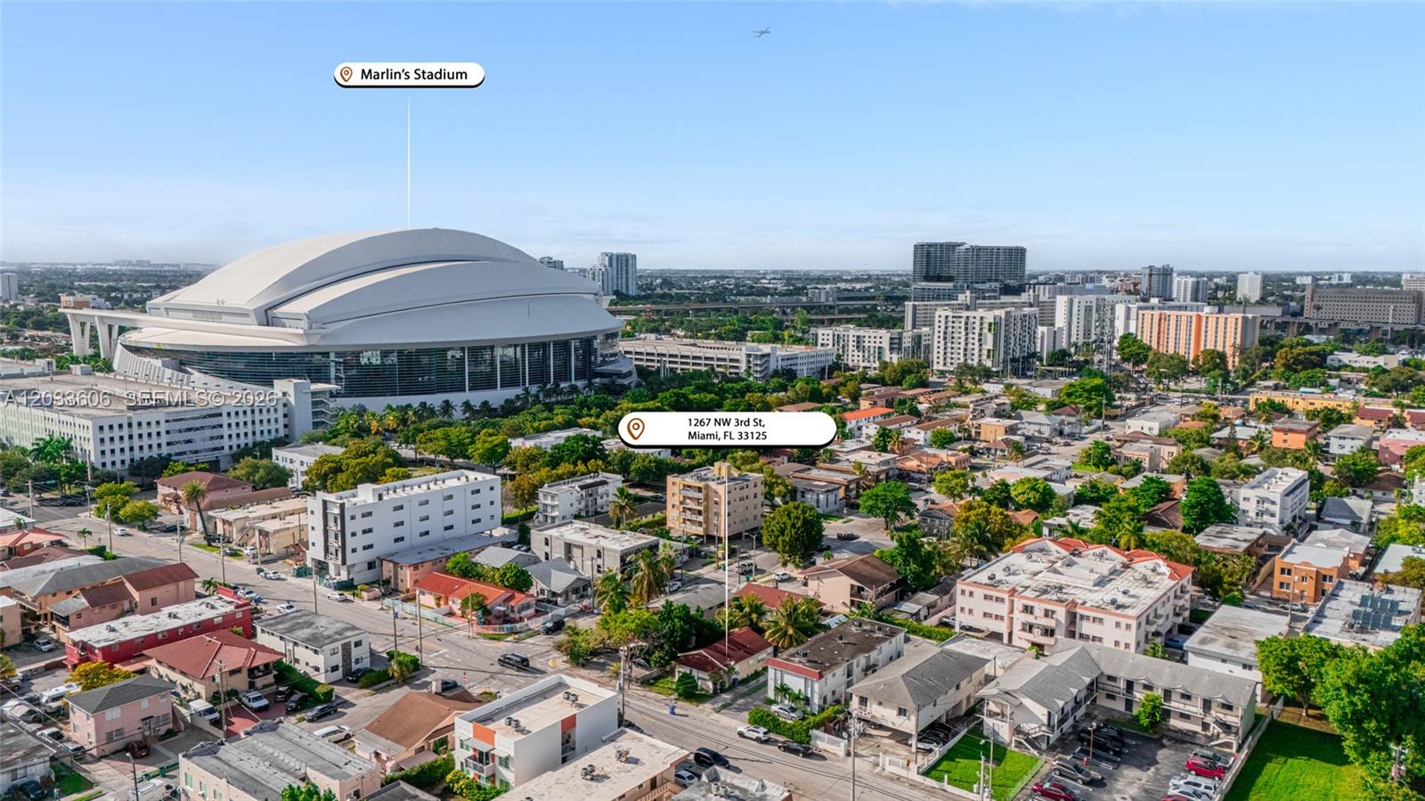 An aerial view shows a residential neighborhood in Miami with a large stadium in the background — 1267 NW 3rd St, Miami FL 33125, MIAMI, FL