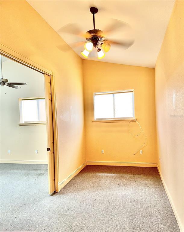 An empty room features yellow walls, gray carpeting, a ceiling fan, and a window — 308 DAL HALL BOULEVARD, LAKE PLACID, FL