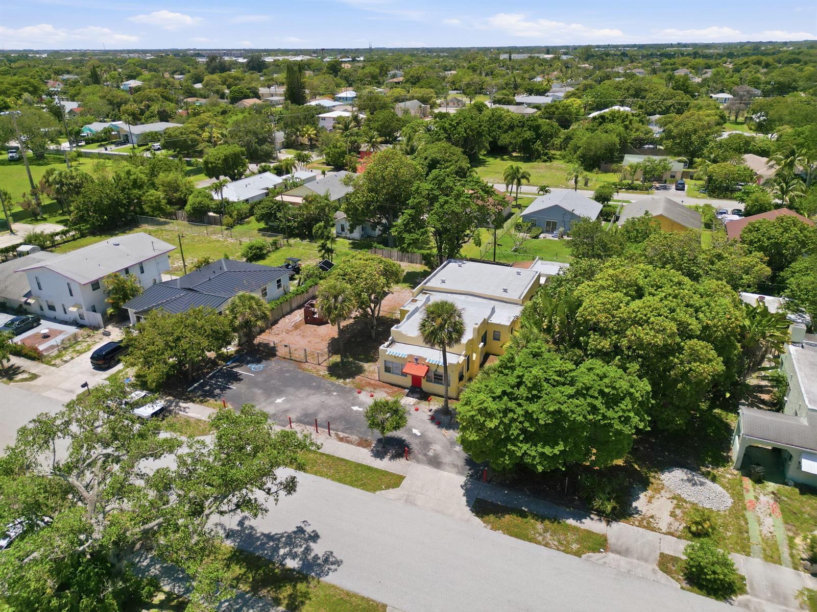 An aerial view shows a yellow commercial building with a parking lot and surrounding trees — 216 SW 2nd Avenue, Delray Beach FL 33444, DELRAY BEACH, FL