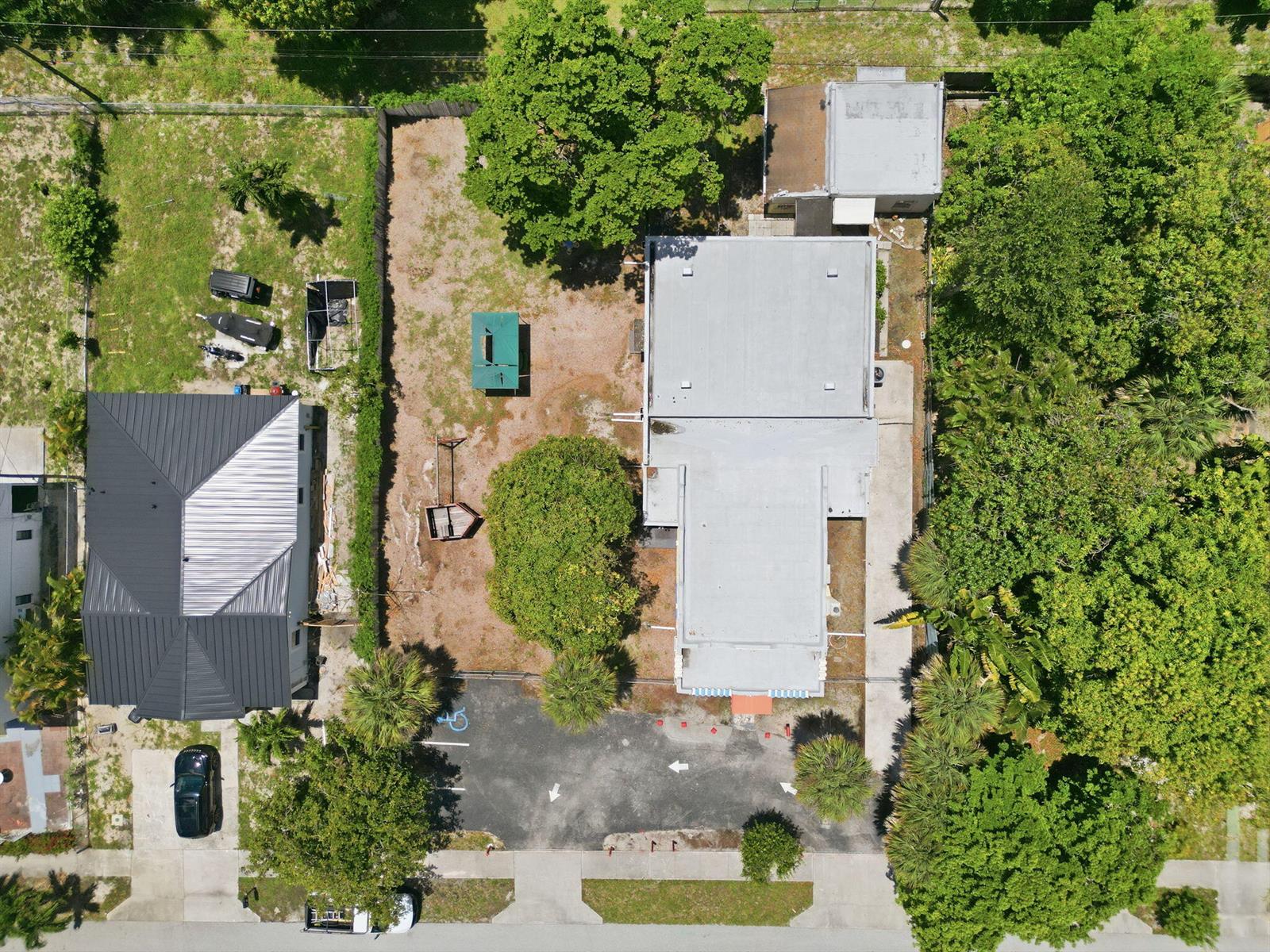 An aerial view shows a commercial building with a parking lot and a large side yard — 216 SW 2nd Avenue, Delray Beach FL 33444, DELRAY BEACH, FL