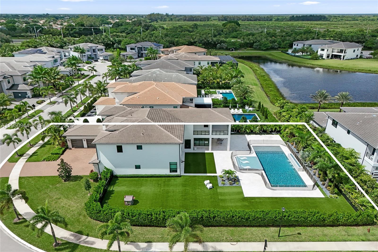 An aerial view shows a two-story house with a swimming pool and large backyard — 17385 Ponte Chiasso Dr, Boca Raton FL 33496, BOCA RATON, FL