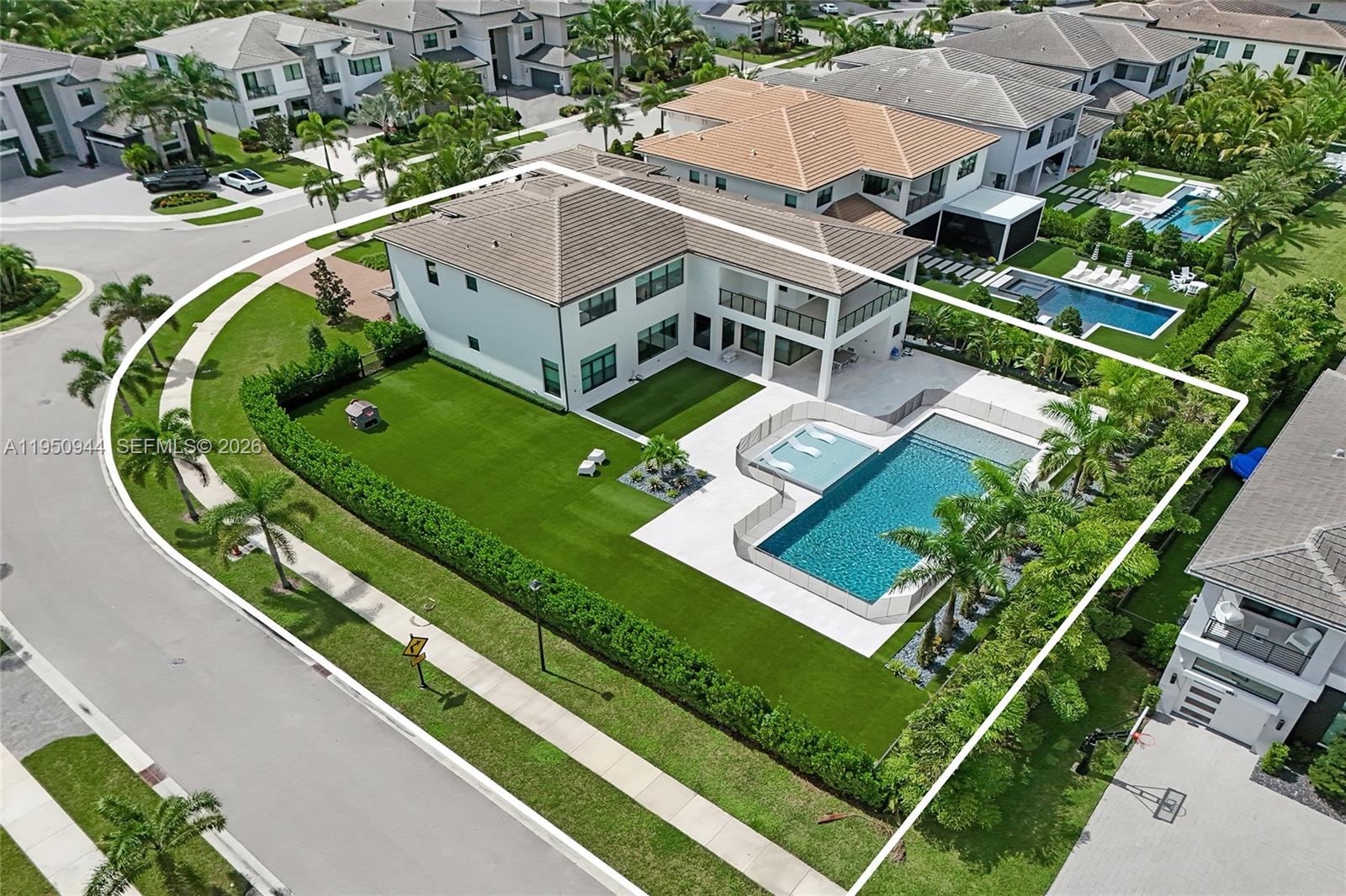 An aerial view shows a two-story house with a backyard pool and artificial turf lawn — 17385 Ponte Chiasso Dr, Boca Raton FL 33496, BOCA RATON, FL