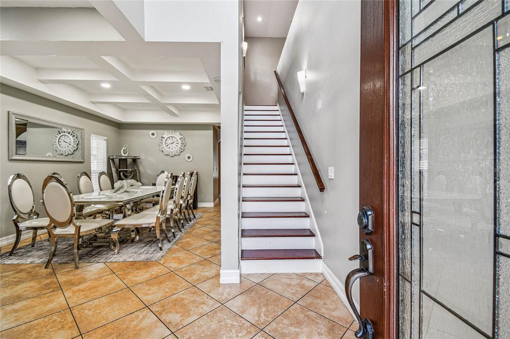 An entryway features a tiled floor, a staircase with wooden treads, and a dining room — 3225 71ST AVENUE N, ST PETERSBURG, FL