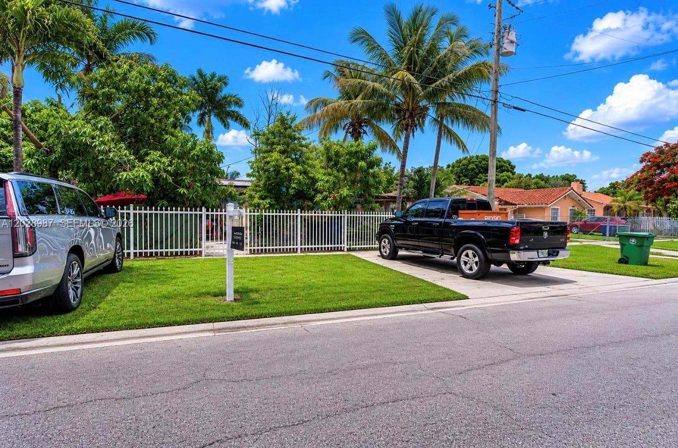A black pickup truck is parked on a driveway in front of a fenced house — 3315 NW 11th Ave, Miami FL 33127, MIAMI, FL