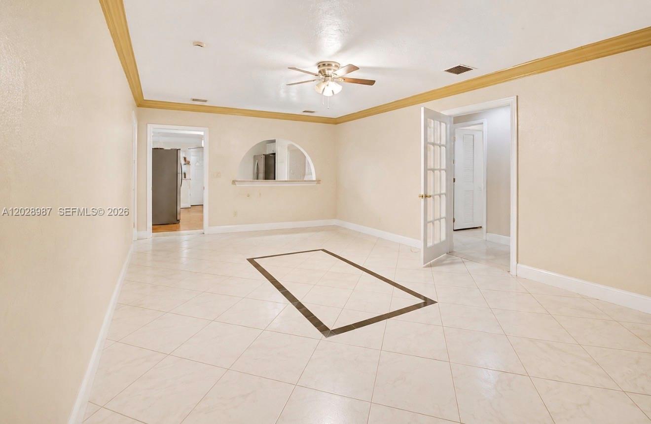 A spacious room features light-colored tile flooring, a central decorative border, and a ceiling fan — 3315 NW 11th Ave, Miami FL 33127, MIAMI, FL