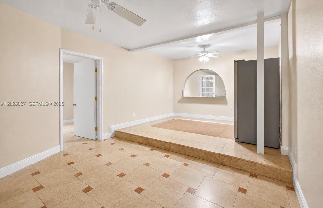 This room features a raised tiled platform, a pass-through arched window, and ceiling fans — 3315 NW 11th Ave, Miami FL 33127, MIAMI, FL