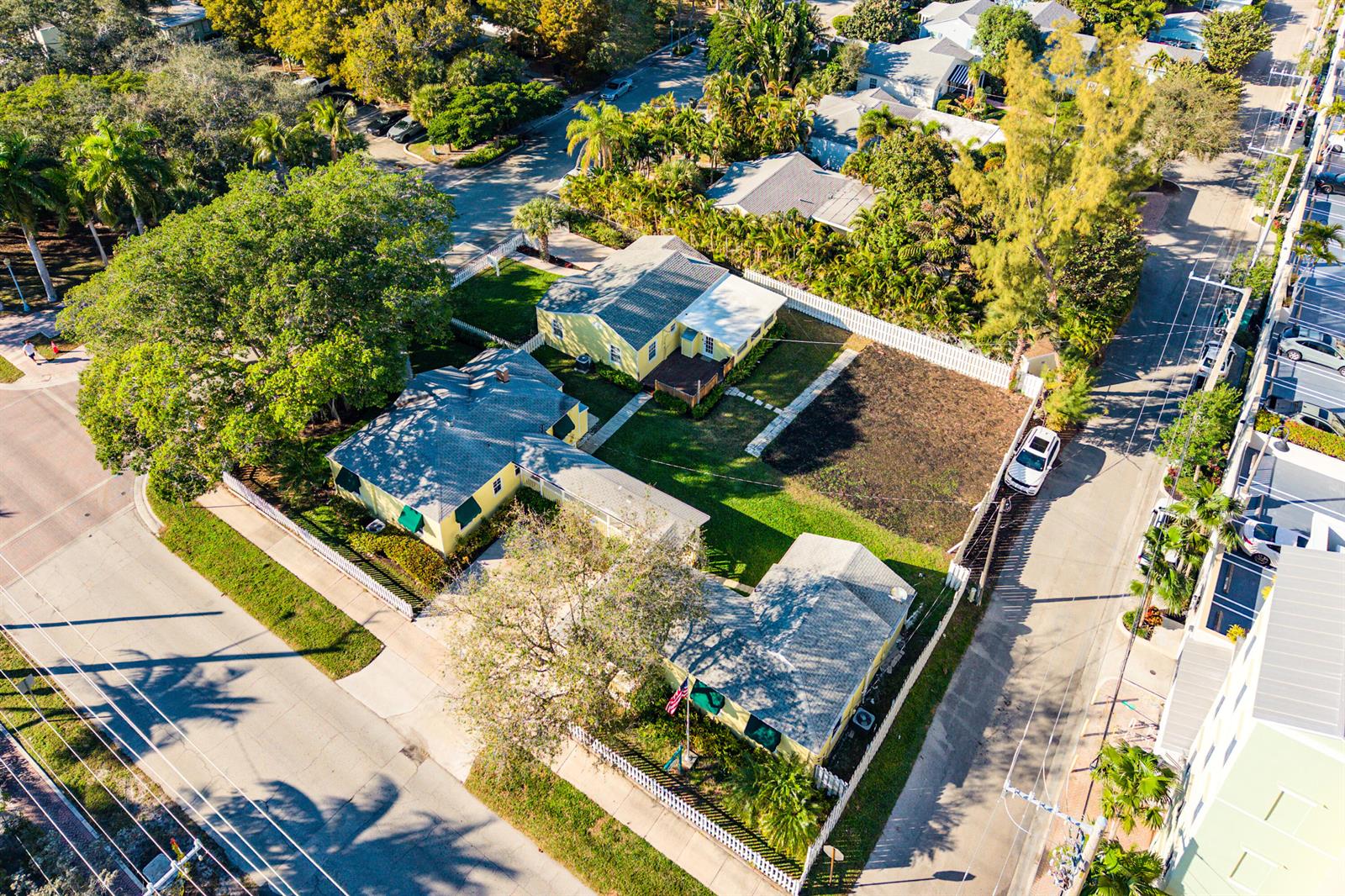 An aerial view shows two yellow houses with gray roofs on a corner lot — 201 NE 1st Avenue, Delray Beach FL 33444, DELRAY BEACH, FL