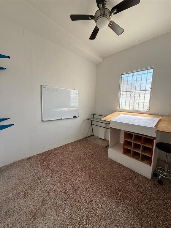 A small room with a ceiling fan, a whiteboard, and a built-in wooden desk unit — 9 URB. LOS ÁNGELES MARGINAL BLQ WA, CAROLINA, PR