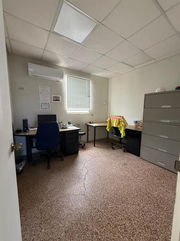 An office room features a speckled floor, two desks, a filing cabinet, and a window — 9 URB. LOS ÁNGELES MARGINAL BLQ WA, CAROLINA, PR