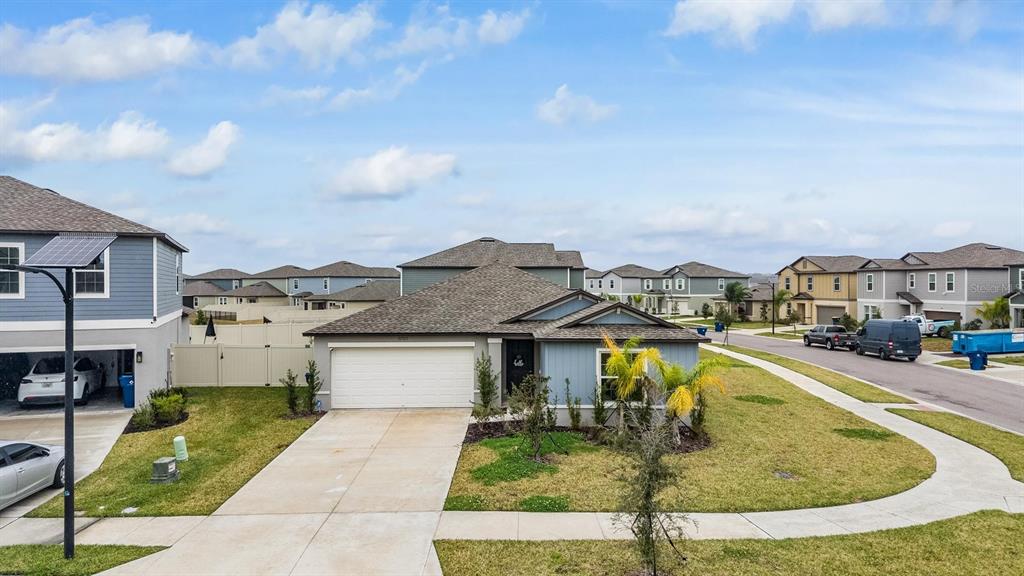 An aerial view shows a large turquoise lagoon with a sandy beach and lounge chairs — 32325 WISHING HAVEN DRIVE, SAN ANTONIO, FL