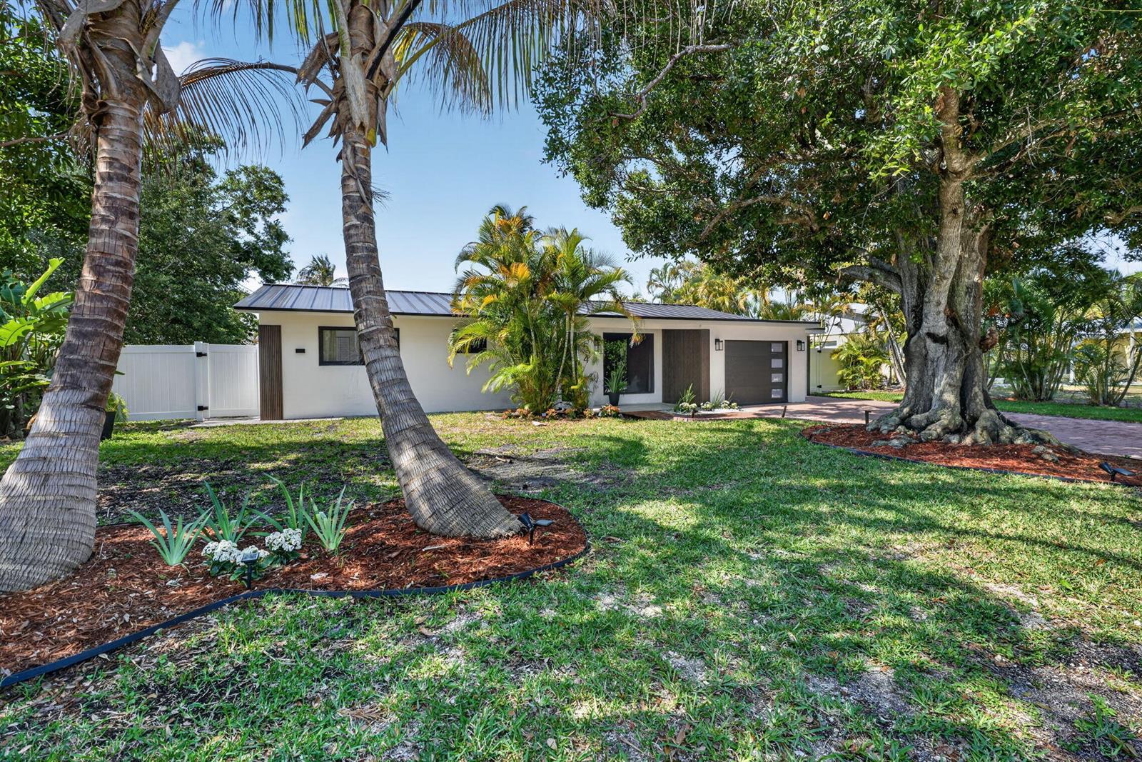 A single-story house with a flat roof, garage, and palm trees in the front yard — 454 Dover Road, Jupiter FL 33469, JUPITER, FL