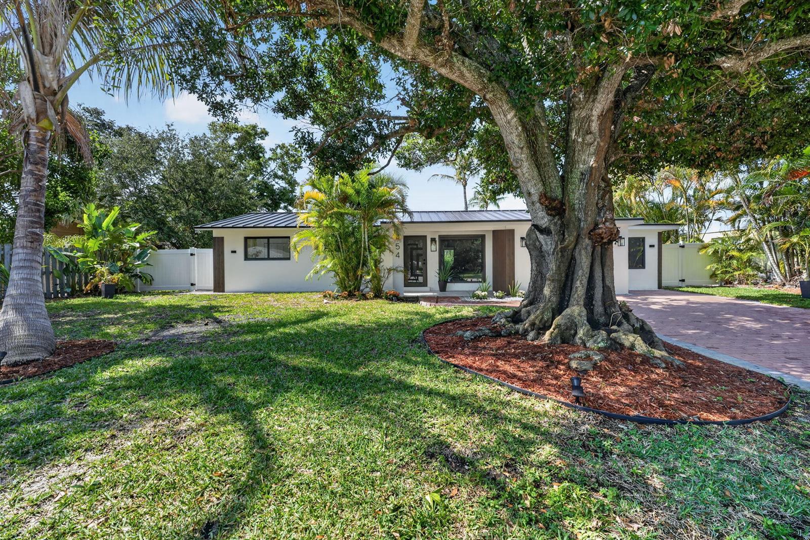 A single-story house with a metal roof and a large tree in the front yard — 454 Dover Road, Jupiter FL 33469, JUPITER, FL