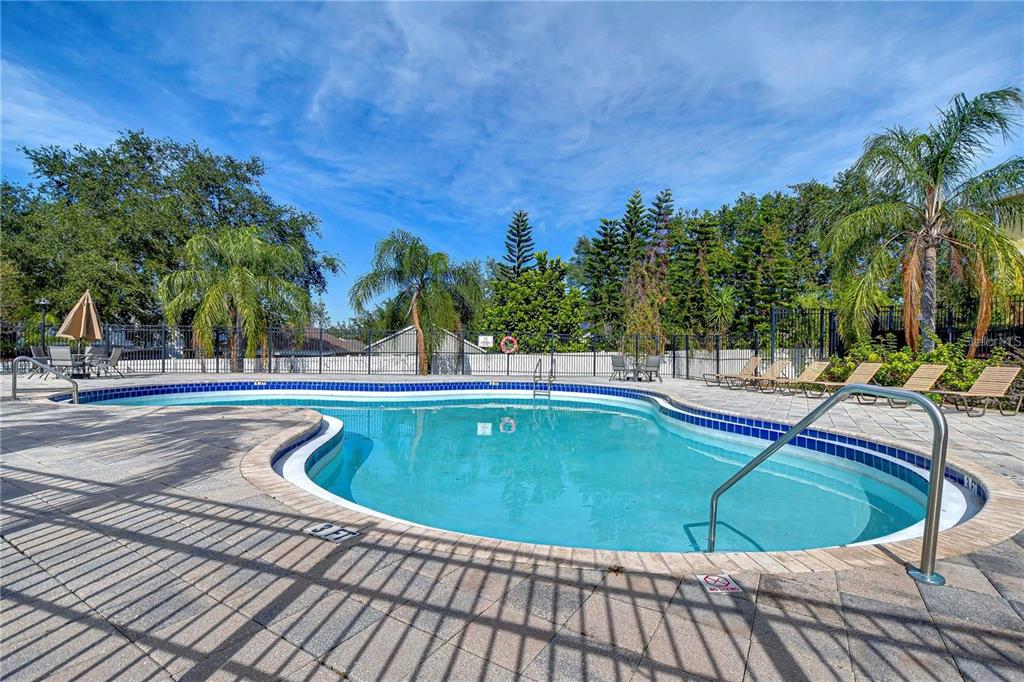 A tan two-story townhouse exterior features a covered front porch with stone pillar accents — 213 DRAW BRIDGE LANE, VALRICO, FL