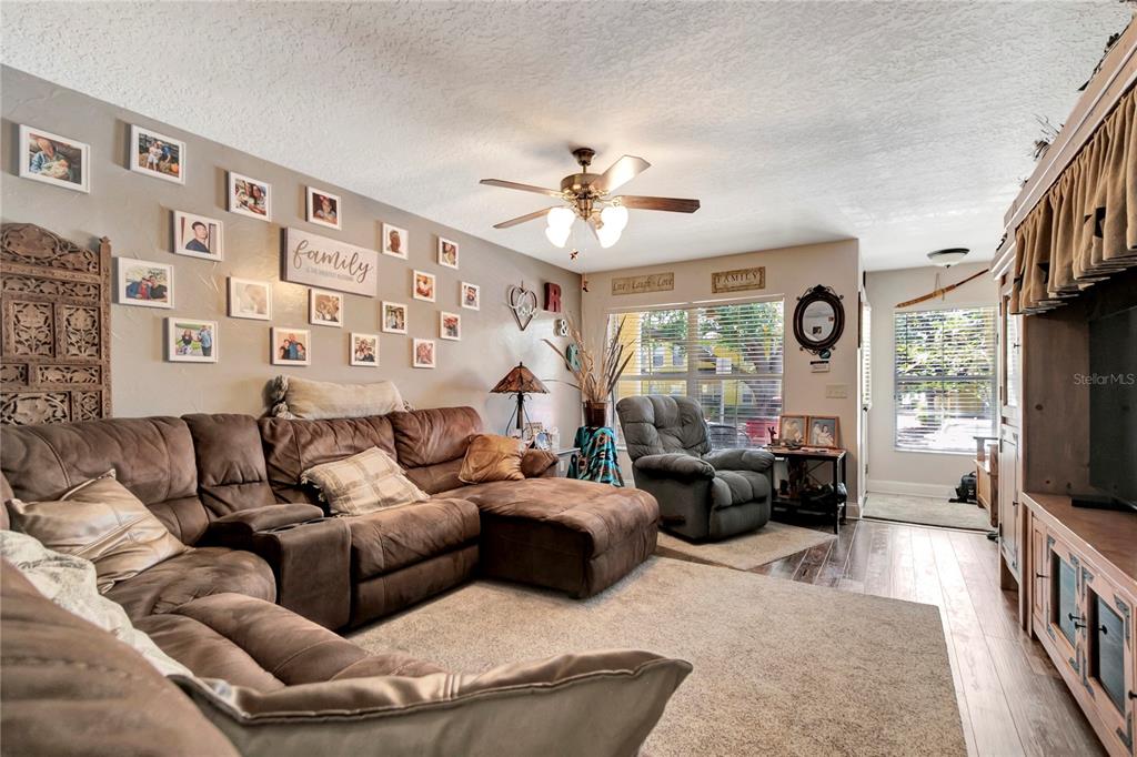 A kitchen features light wood cabinets, granite countertops, stainless steel appliances, and tiled flooring — 213 DRAW BRIDGE LANE, VALRICO, FL