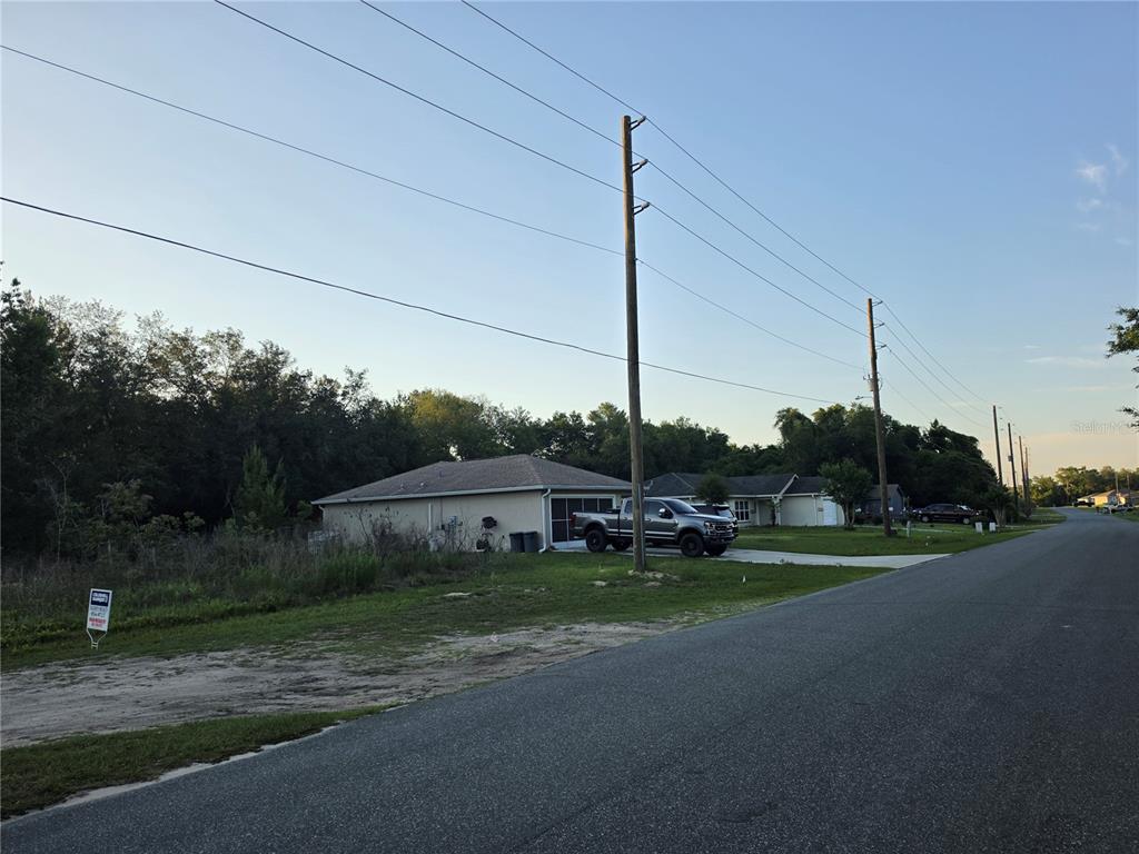 A street view shows a house with a driveway and a large utility pole — SW 18TH AVE RIVER, OCALA, FL