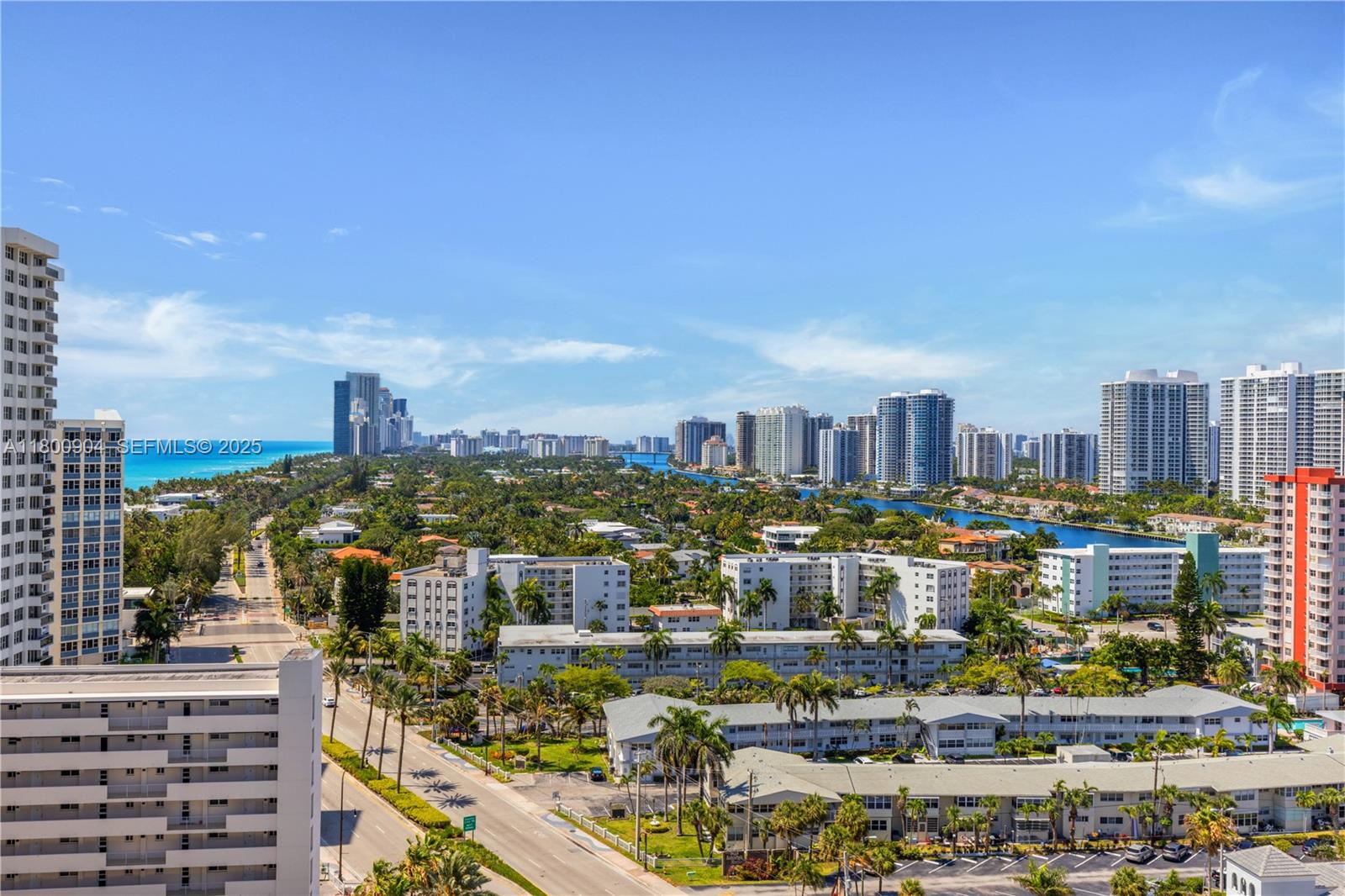 An elevated view of a coastal city featuring high-rise buildings, residential complexes, and lush greenery — 2030 S Ocean Dr # 1707, Hallandale Beach FL 33009, HALLANDALE BEACH, FL