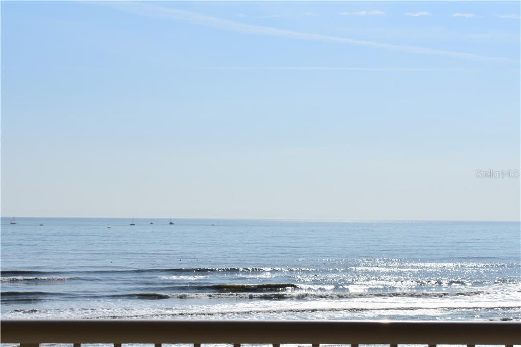 A view of the ocean and horizon from a balcony with a railing — 701 N ATLANTIC AVENUE W UNIT 401, NEW SMYRNA BEACH, FL