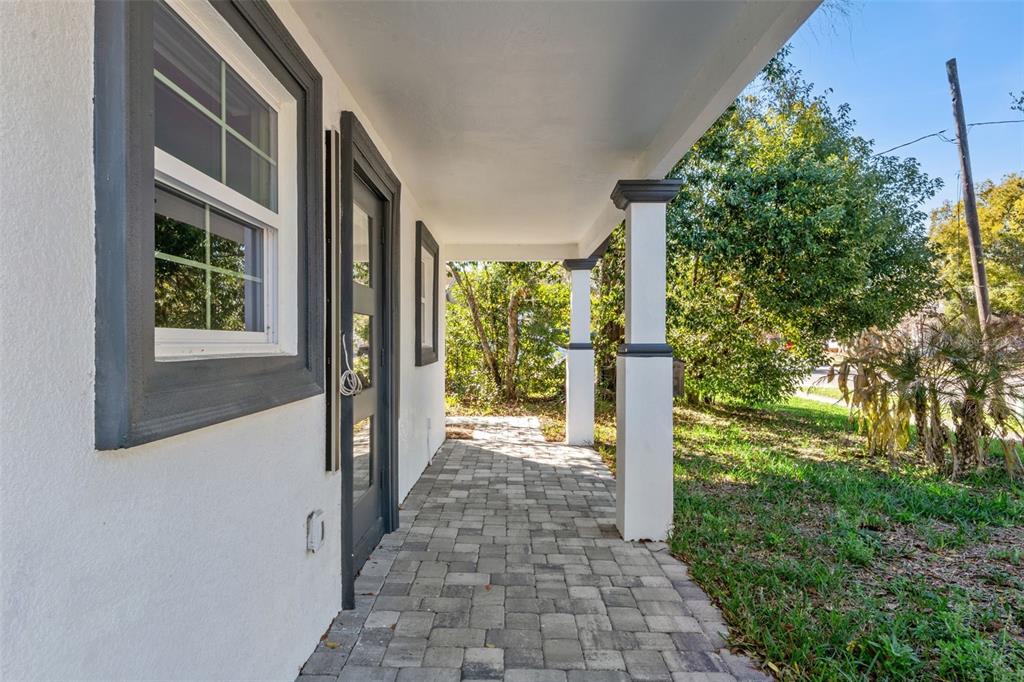 A paved front porch features white columns and a dark-framed door and window — 1354 INDIANA AVENUE, WINTER PARK, FL