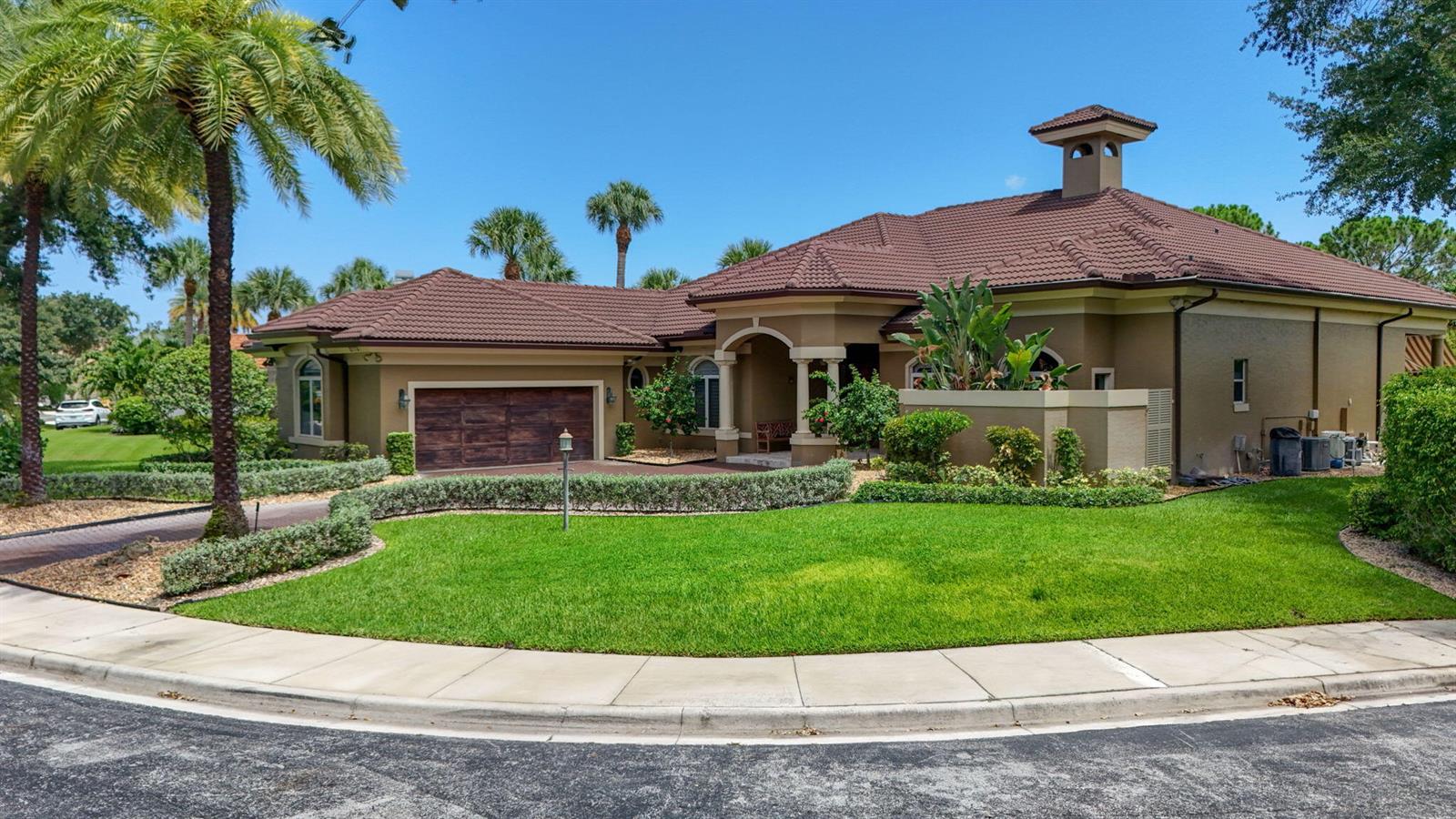A single-story house with a brown tile roof, tan stucco walls, and a wooden garage — 2773 Tecumseh Drive, West Palm Beach FL 33409, WEST PALM BEACH, FL