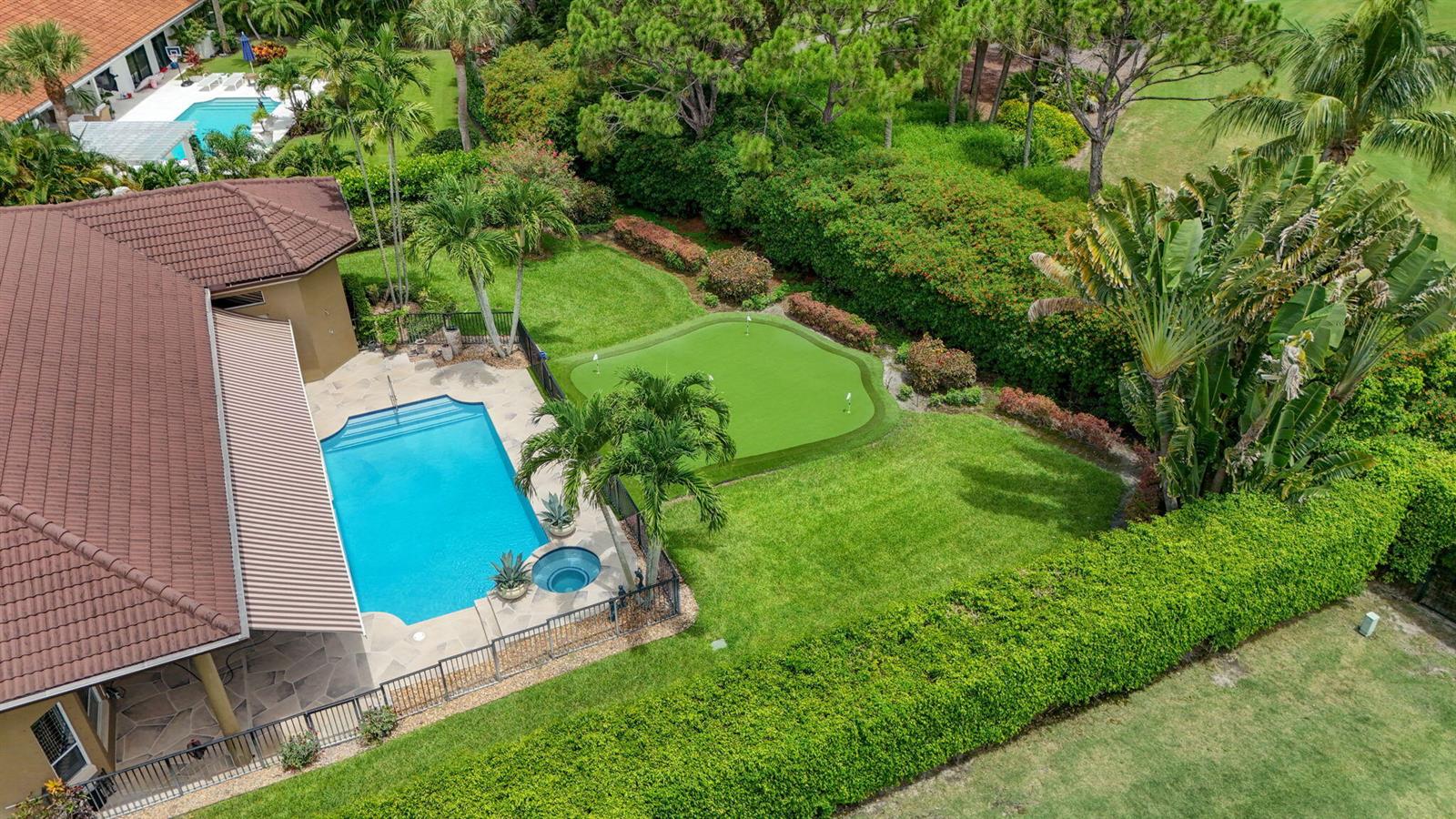 An aerial view of a backyard featuring a swimming pool, spa, and putting green — 2773 Tecumseh Drive, West Palm Beach FL 33409, WEST PALM BEACH, FL