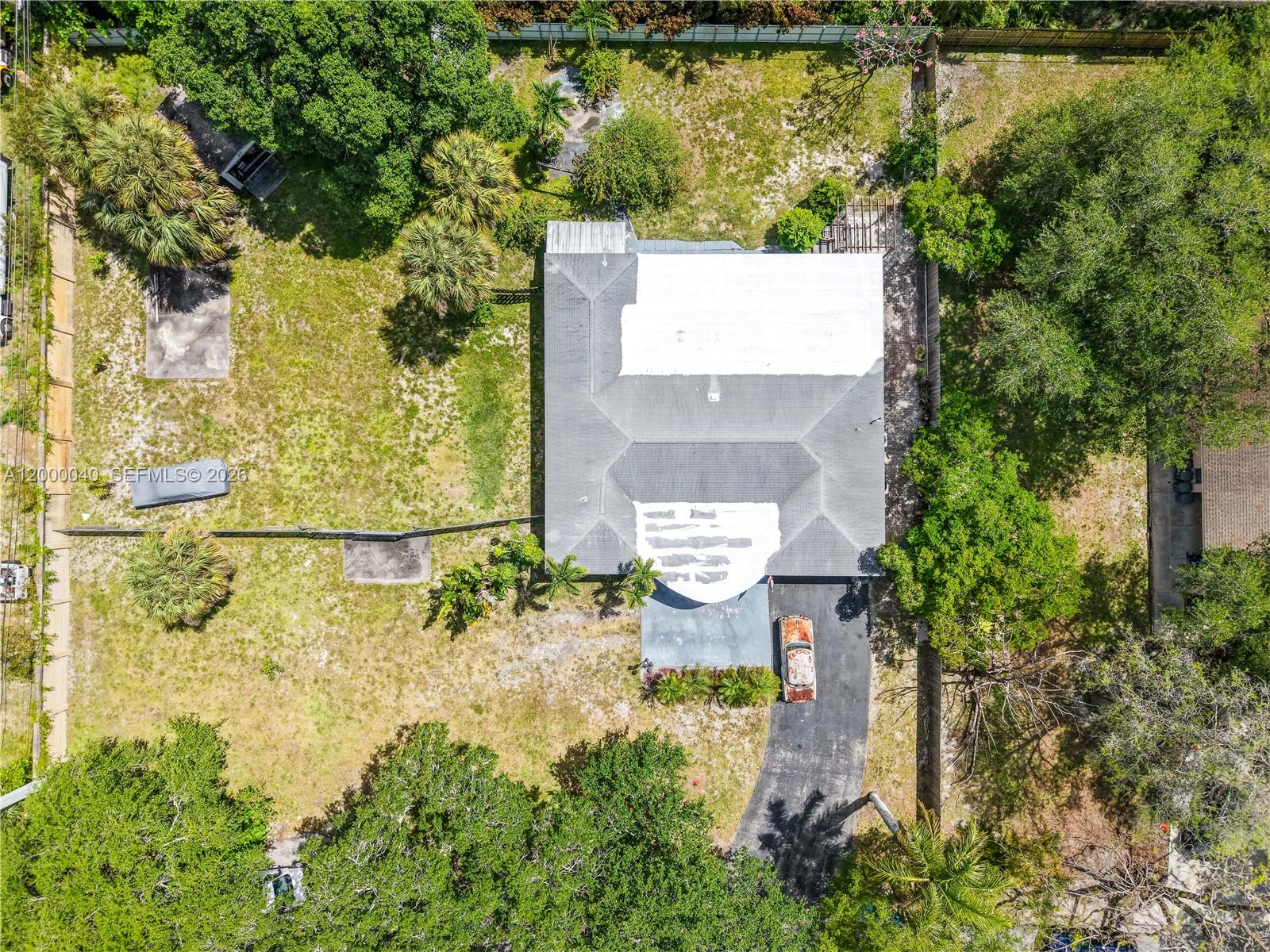 An aerial view shows a house with a partially white roof and a driveway — 4020 SW 2nd St, Plantation FL 33317, PLANTATION, FL