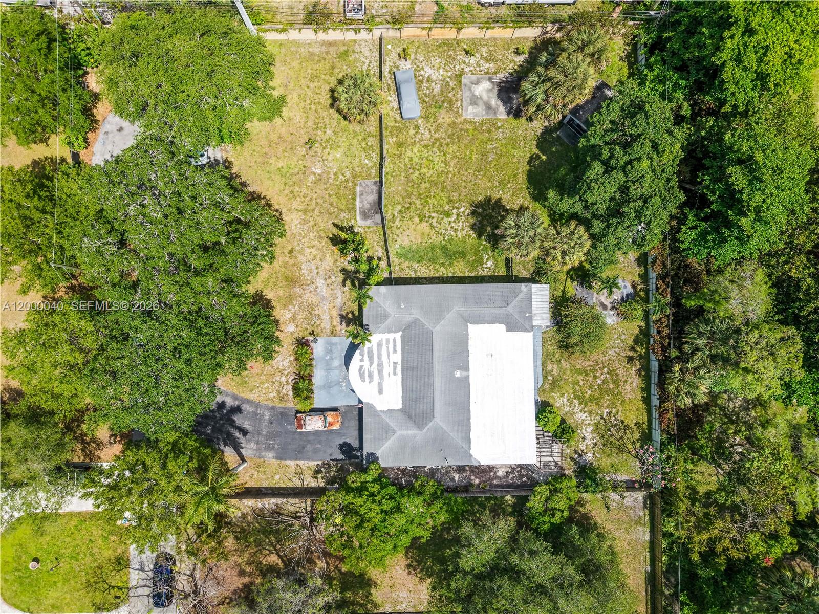 An aerial view shows a house with a partially white roof and a large backyard — 4020 SW 2nd St, Plantation FL 33317, PLANTATION, FL