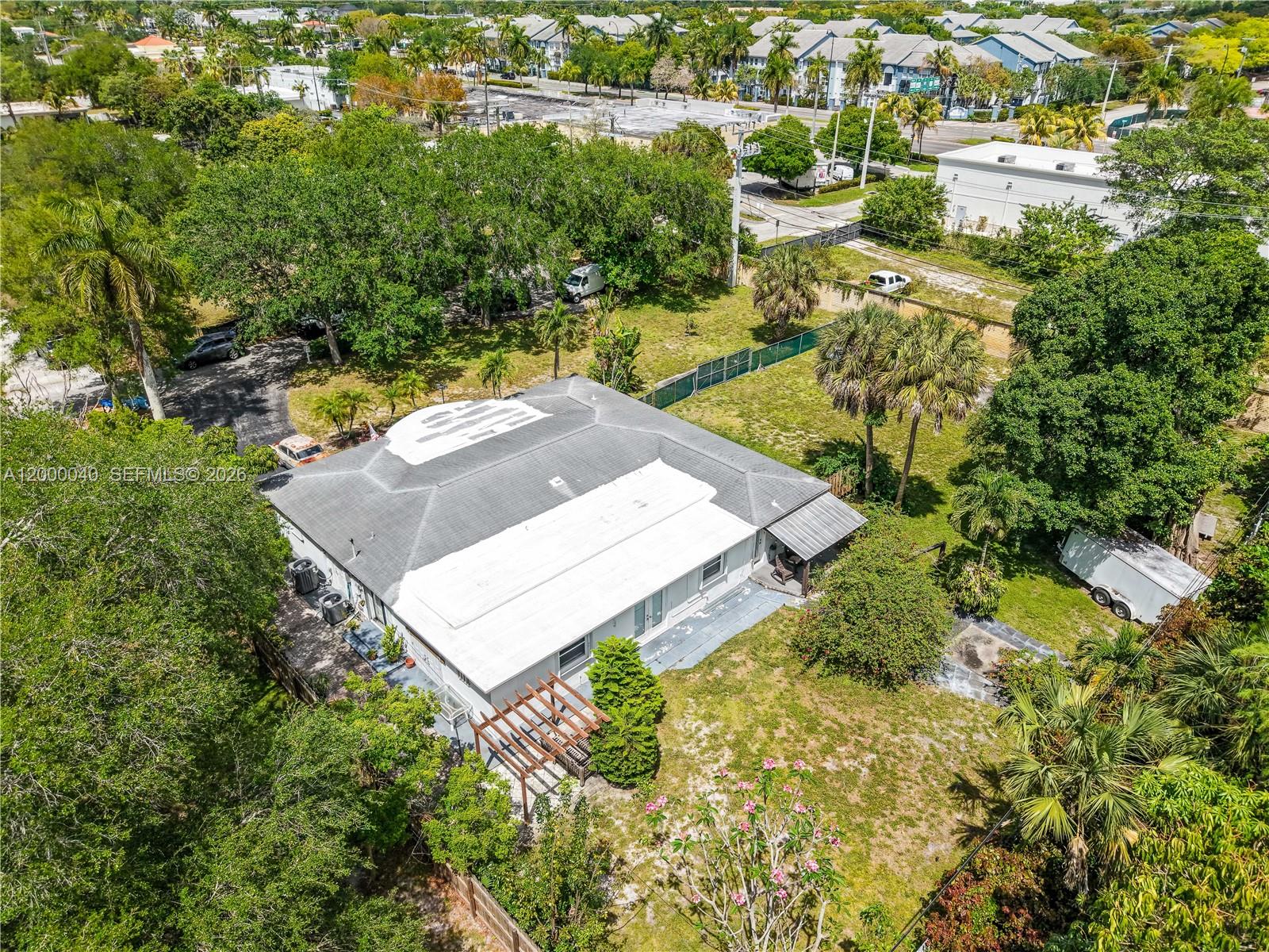 An aerial view shows a single-story house with a white roof and a wooden pergola — 4020 SW 2nd St, Plantation FL 33317, PLANTATION, FL