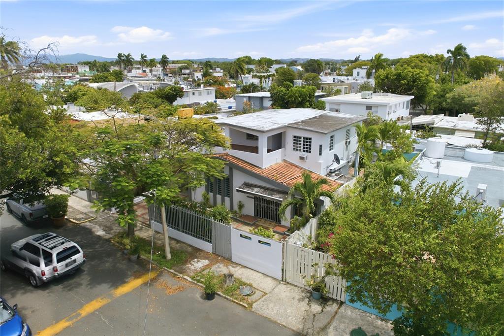 An aerial view shows a two-story white house with a tiled roof and fenced yard — 2202 GENERAL PATTON, SAN JUAN, PR