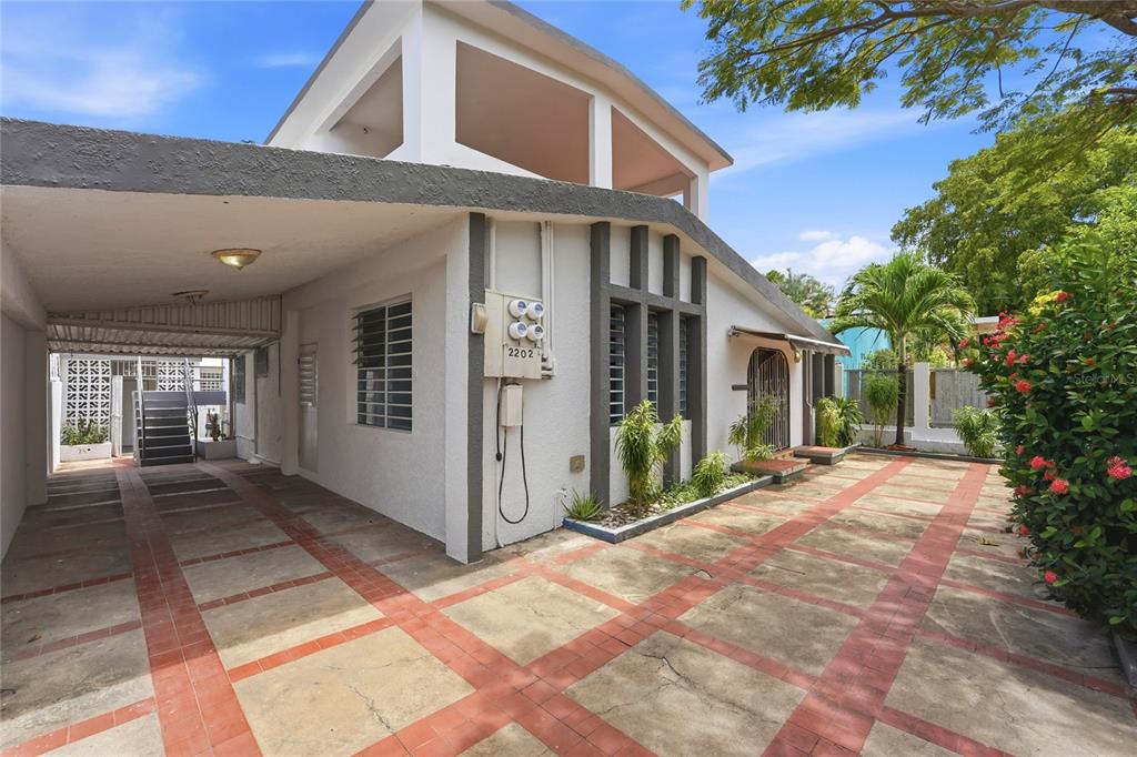 A white house with a carport, a tiled driveway, and a second-story balcony — 2202 GENERAL PATTON, SAN JUAN, PR