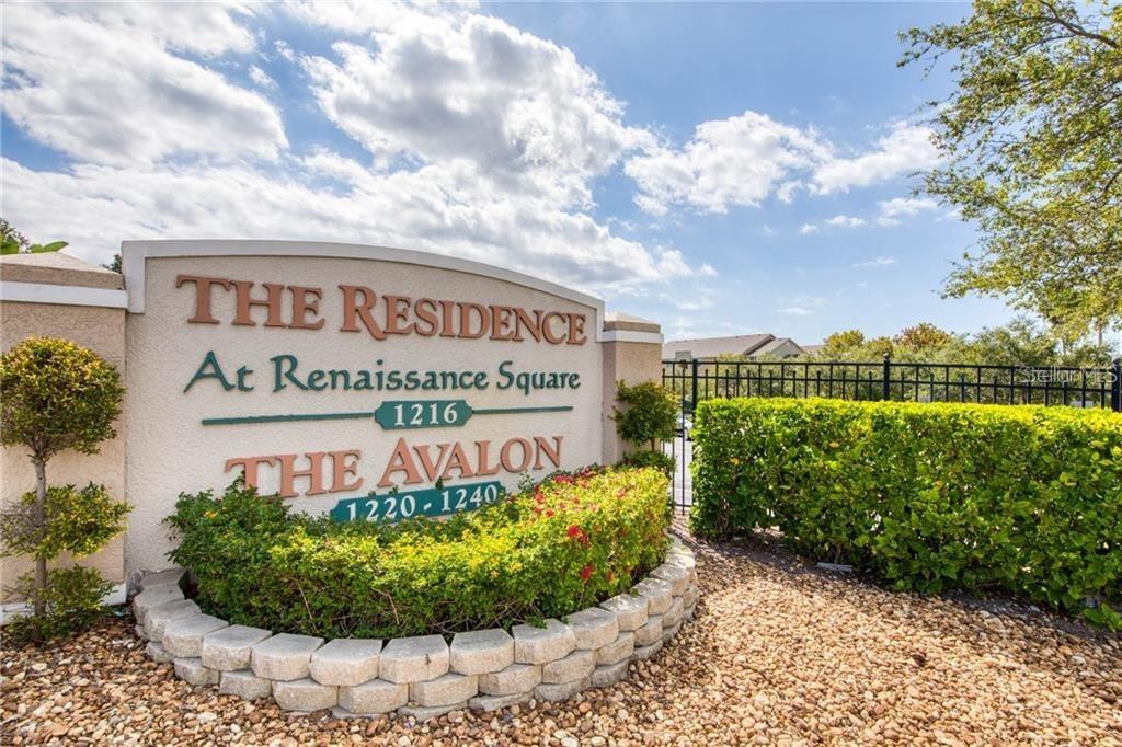 A beige monument sign for a residential community stands in front of a landscaped garden — 1216 S MISSOURI AVENUE UNIT 228, CLEARWATER, FL